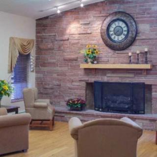 Cozy living room with a stone fireplace and comfortable seating.