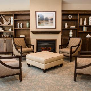A cozy living room with elegant furniture and a warm fireplace.