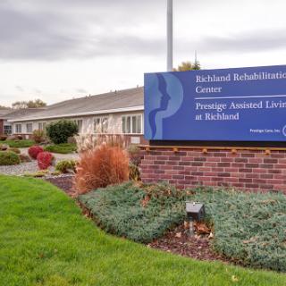 Exterior view of a rehabilitation center showcasing well-maintained landscaping and clear signage.