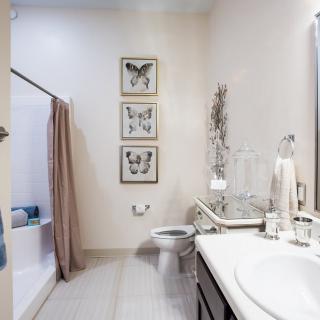 A stylish bathroom with butterfly artwork and modern decor.