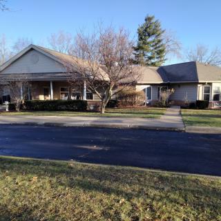 A suburban residential house with a front yard and driveway.
