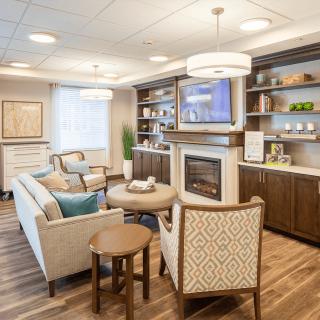 A modern and cozy living room with comfortable seating and a fireplace.