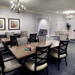 A well-appointed dining room featuring elegant chandeliers and comfortable seating.
