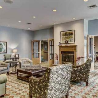 A cozy living room with a fireplace and comfortable seating arrangement.