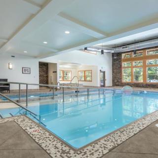 A modern indoor swimming pool with ample natural light and contemporary design.