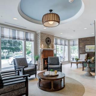 A modern living room with ample natural light and stylish furnishings.