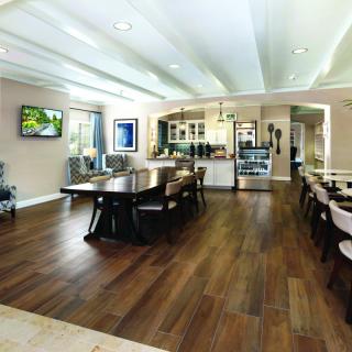 A spacious modern kitchen and dining area with wood flooring and contemporary furnishings.