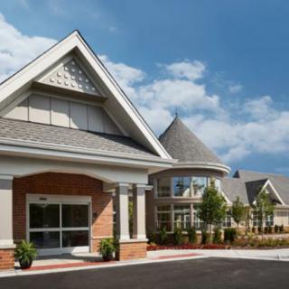 A modern residential building with distinctive architectural features against a blue sky.