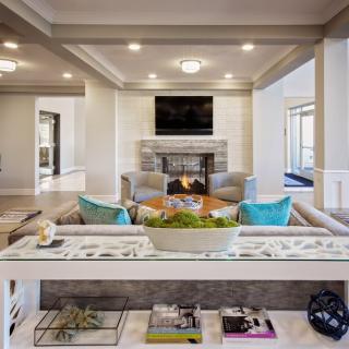 A modern living room featuring a cozy fireplace, stylish sofas, and a mounted television.
