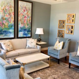 A beautifully decorated living room featuring comfortable seating and colorful artwork.