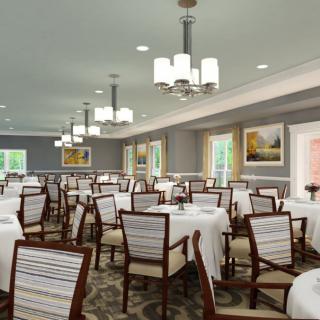 Modern dining room with neatly arranged tables and chairs, elegant lighting, and tasteful decor.
