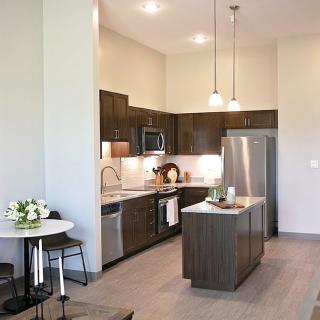 A modern kitchen with an island and stainless steel appliances.
