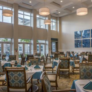 Elegant dining area with large windows and sophisticated decor.
