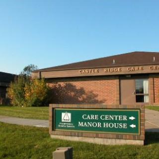 A view of a care center and manor house with clear signage indicating the facilities.