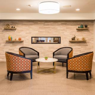 A stylish and inviting seating area featuring modern chairs and a central table, perfect for relaxation or conversation.