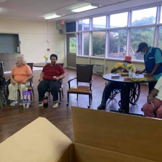 Elderly individuals engaged in a group activity at a care facility.