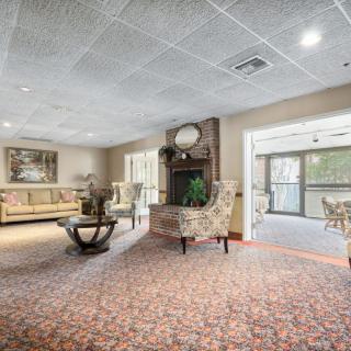 A cozy lobby interior with elegant furniture and ample natural light.