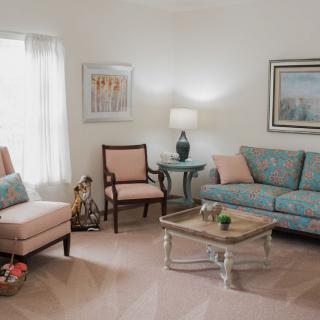 A cozy living room featuring a comfortable sofa, armchair, and a well-decorated interior.