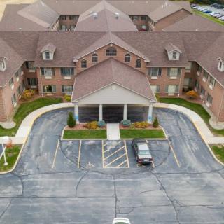 Aerial view of a residential building with a parking lot.