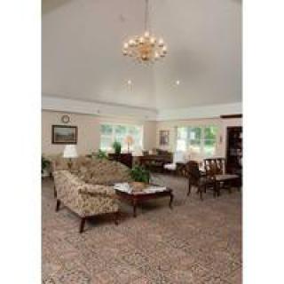 A spacious living room with elegant furniture and a chandelier.