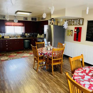 Cozy kitchen and dining area with wooden flooring and modern appliances.