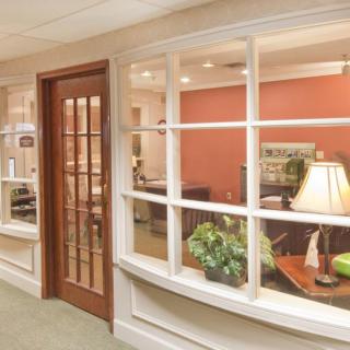 A cozy office interior with a wooden door, glass windows, and a welcoming waiting area.