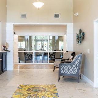 A bright and welcoming living space featuring comfortable seating and tasteful decor.