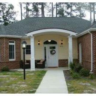 Front view of a brick residential house with a small porch.