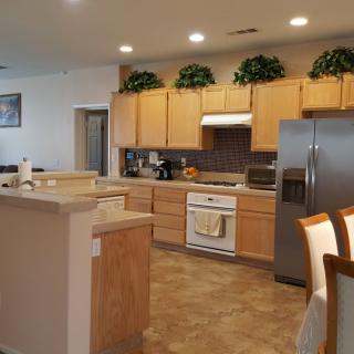 A modern kitchen with wooden cabinets and stainless steel appliances.