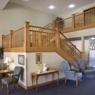 A cozy interior with a wooden staircase and seating area.