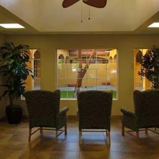 A cozy waiting area with chairs facing a large window overlooking a courtyard.
