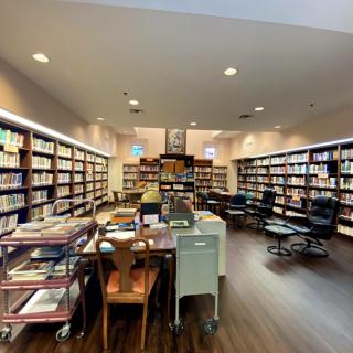 A spacious library with rows of bookshelves and a cozy reading area.