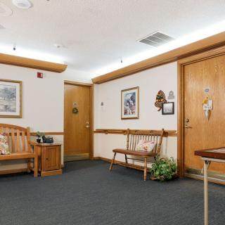 A quiet waiting room with seating and artwork on the walls.
