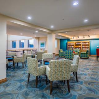 A modern indoor lounge area featuring comfortable seating and vibrant decor.