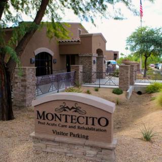 Entrance to Montecito with a visitor parking sign and landscaped surroundings.