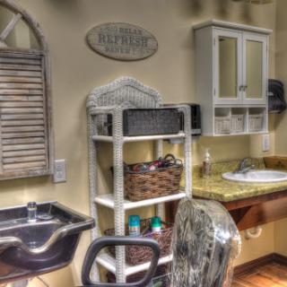 An inviting salon interior featuring a hair washing station and organized storage.