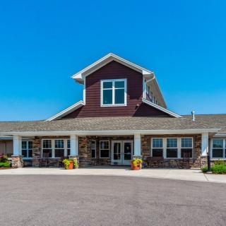 A residential building with a welcoming entrance under a clear blue sky.