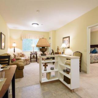 A cozy living room with warm lighting and comfortable furniture.