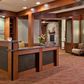 Modern office reception area with a welcoming desk and comfortable seating.