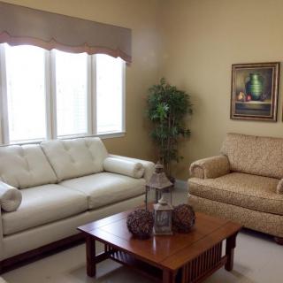 A cozy living room with two sofas, a coffee table, and wall decor.