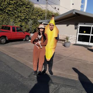 A playful moment featuring two individuals in humorous costumes, one dressed as a banana and the other resembling an animal.