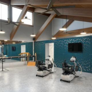 A spacious and modern fitness center featuring exercise bikes and vibrant decor.