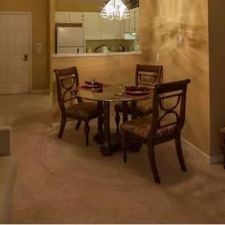 A cozy dining area with a two-chair table set adjacent to an open kitchen.