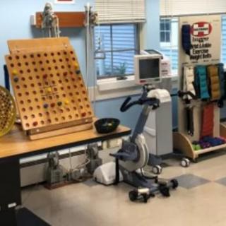 A physical therapy room equipped with various rehabilitation tools and exercise machines.