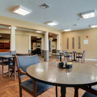 An empty dining area with tables and chairs arranged neatly.
