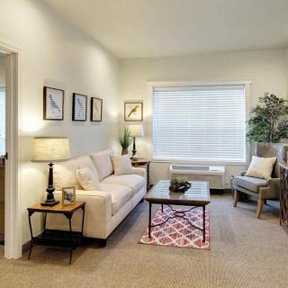 Cozy living room with comfortable seating and soft lighting.