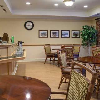 A cozy seating area with wooden furniture and decorative elements, resembling a small caf.