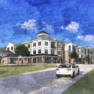 A car approaches a large, multi-story building under a bright blue sky.