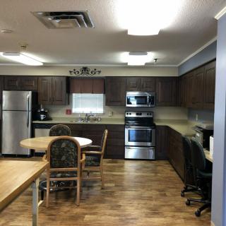 A spacious kitchen with modern appliances and wooden flooring.