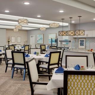 A modern dining room with neatly arranged tables and stylish lighting.